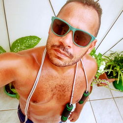 Shirtless Man in Sunglasses Sharing Photo