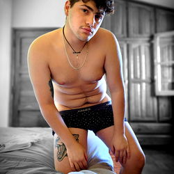 Corderito: Shirtless, Tattooed Model in a Bedroom