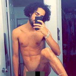 Fit and Shirtless Model Posing in Bathroom