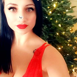 AutumnFaye9 posing in festive red and black lingerie in front of a Christmas tree