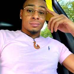 A Young Man in a Pink Shirt and Necklace