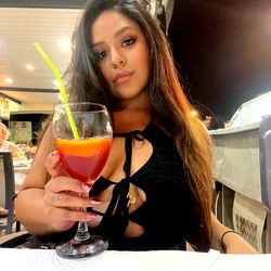 Ceci posing at a restaurant with a drink