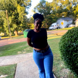 Woman in Black Tank Top Posing Outside