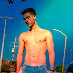 JP, a Mexican fitness model in a casual outfit and urban setting.