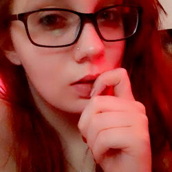 Red-haired woman in glasses with pink lips