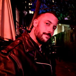 Stylish Man in Black Jacket Posing