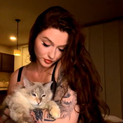 Anya on Onlyfans: A Young Woman Captured in a Cozy Moment with Her Cat