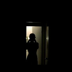 Oyku, the silhouette of a woman in a dimly lit room