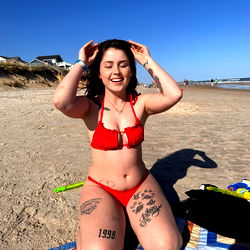 Model Posing on Beach in Red Bikini