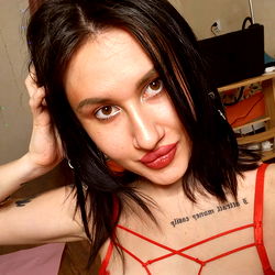 Sexy Woman in Red Shirt, Tattoos, and Earrings, Striking a Pose