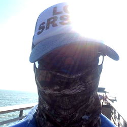 Cool Guy in Camo Face Mask at Ocean