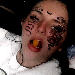 A playful photo of a young woman enjoying her meal.