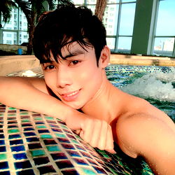 Young, Shirtless Man Posing for Selfie in Swimming Pool