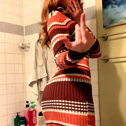 Mysterious Woman in Brown and White Dress, Striking a Pose in Bathroom