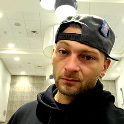 Young Man in a Hat Taking Selfie