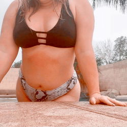 Allana Jade, a 23-year-old female model on OnlyFans, enjoying her time in a poolside setting.