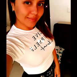 A Woman in a White T-shirt with Slogan and Black Belt, Taking a Mirror Selfie