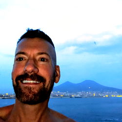 Beautiful sunset over the sea with a smiling man