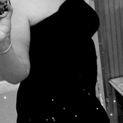 Onlyfans model Ashly posing in a sleek black dress