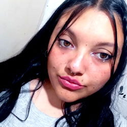 A young adult woman with long hair, sporting a vibrant red lipstick, in the midst of an OnlyFans moment.