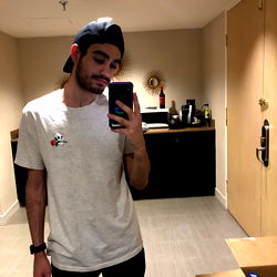 A Young Man Standing in a Bathroom