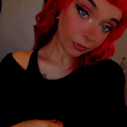 Chic Red-Haired Female with Daring Makeup and Tattoos, Embracing the Grunge Aesthetic