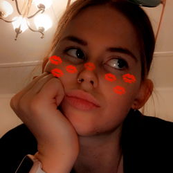 Sarah, a young woman with captivating eyes and a playful expression