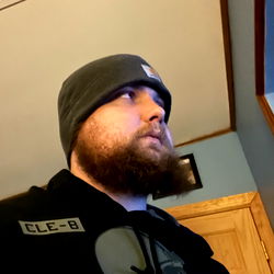 A man in a beanie cap at home