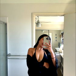 A Model Posing in a Bathroom Mirror