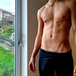 Fit Model Showcasing Abs and Shorts in Daylight