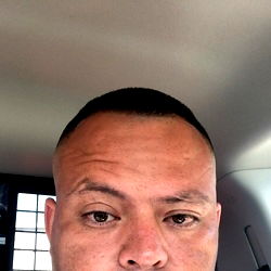 Shaved-Head Man in Car Interior