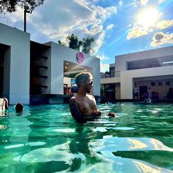 An Adult Male Swimming in an Outdoor Pool