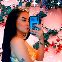 Onlyfans Model Posing with a Flower Wall in the Background