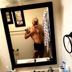 Fitness-Minded Man Showcasing Body in Mirror