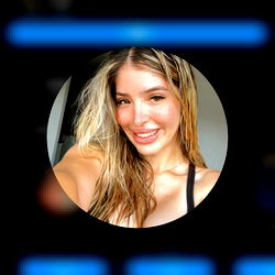 A person in a mirror reflection with the phone displaying an image of the same individual.