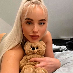 Amber Vogt, a model on OnlyFans, poses with a teddy bear
