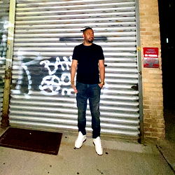 Kris Romario Standing Outside a Metal Door