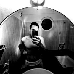 Kostas, a fitness enthusiast captured in a small restroom mirror