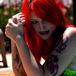 Red-haired tattooed model in bathing suit