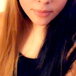 A young woman with dark hair and a black tank top