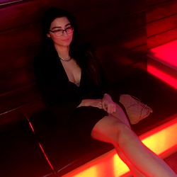 Risxxx, a OnlyFans Model Poses in Booth for Social Media Content