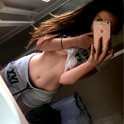 A model posing for OnlyFans in a bathroom