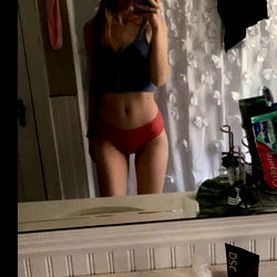 Red Angel Showcasing Her Figure in Bathroom Mirror