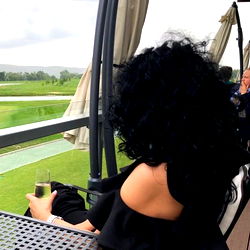 Fashionable Woman Savoring a Glass of Wine on an Outdoor Deck
