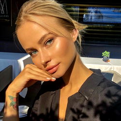 Stylish Model Stasya Posing Outdoors with Hand on Chin