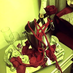 Intimate Setting with Red Roses and Bottle of Champagne