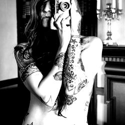 Tattooed Model with Camera in Hand