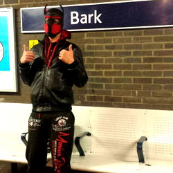 Costumed Individual on Platform Waiting for Train