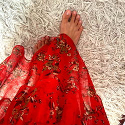 Vivid Red Flowers on Fluffy White Carpet, Foot in Red Shoe