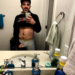 A man in the midst of a bathroom routine, showcasing a glimpse into his life.